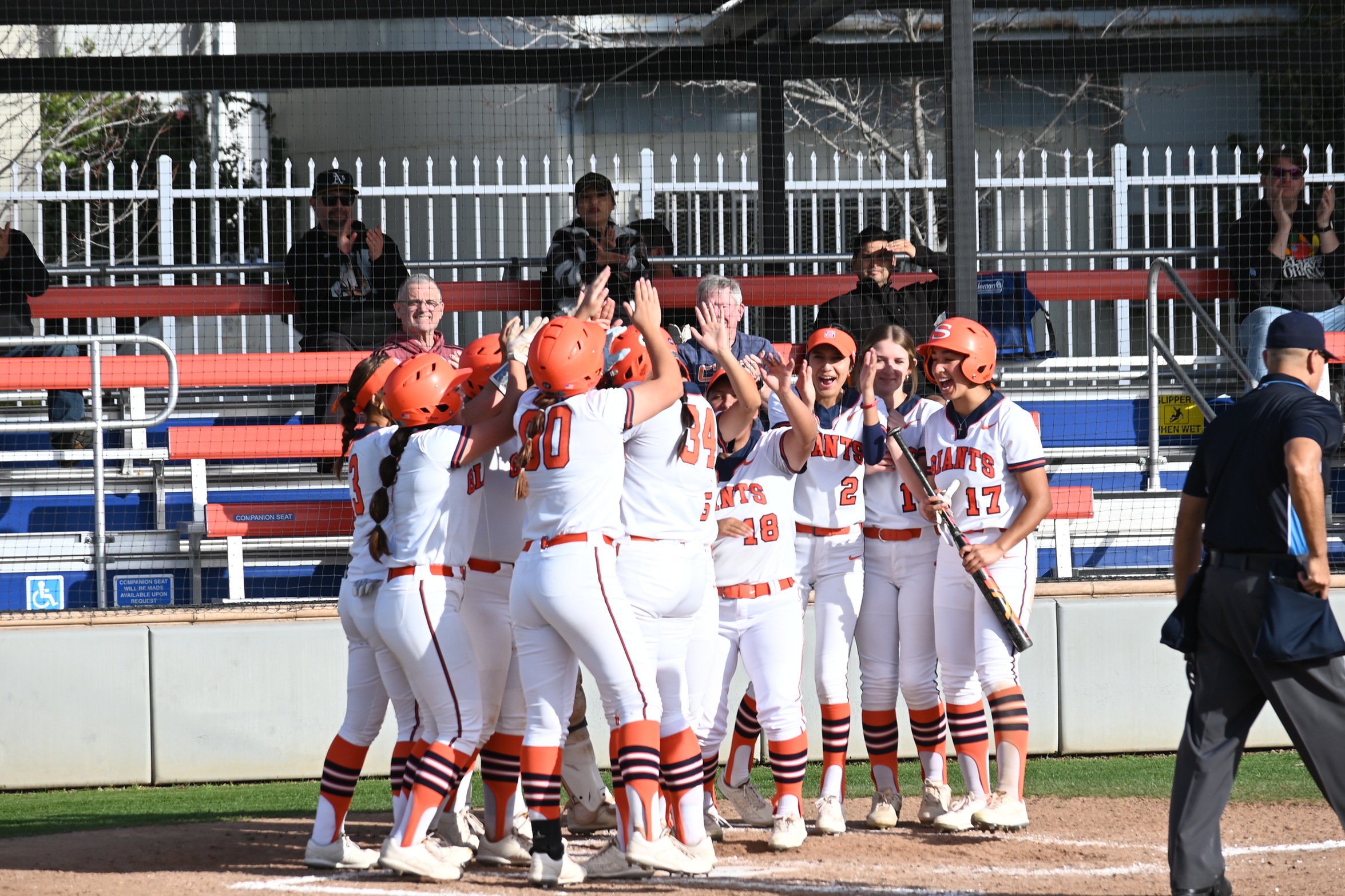 College of the Sequoias' softball team celebrating after Taylor Hastin's (34) 3-run homerun in the game versus Butte on February 12, 2025. (Photo Credit: Norma Foster / COS Athletics)