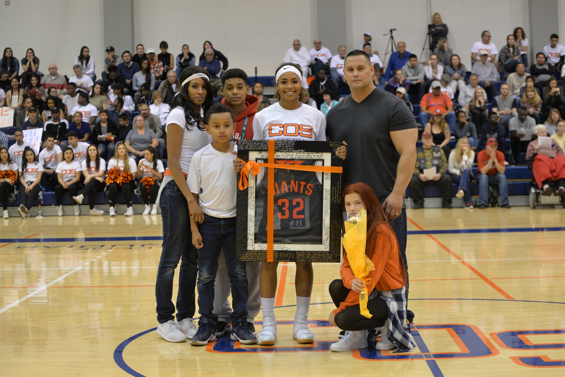 Rubalcava (middle) holding her framed jersey on Sophomore Night.